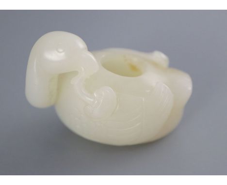 A Chinese white jade 'duck' brushwasher, the figure of the duck with his head turned to the left biting a sprig of lingzhi, t