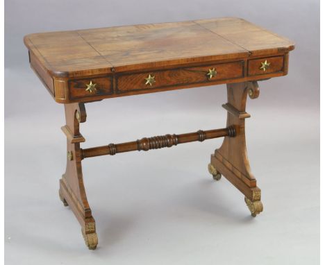 A Regency brass strung rosewood games table, with sliding reversible chess board top enclosing a backgammon board, over two f