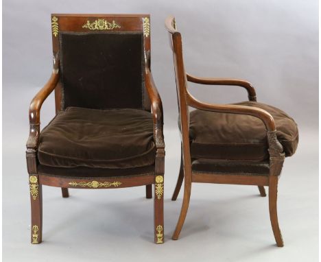 A pair of 19th century French Empire style ormolu mounted mahogany fauteuils, with cherub and lyre decoration, padded backs a