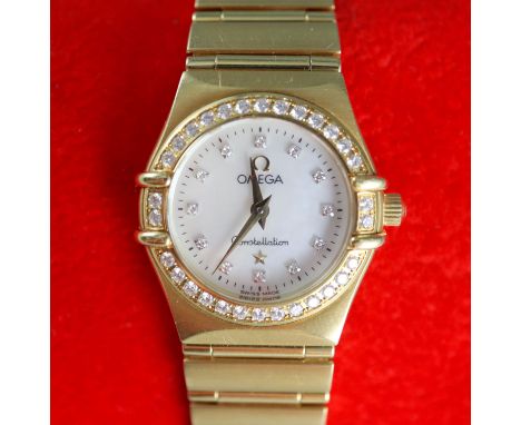 A lady's 1990's 18ct gold Omega Constellation quartz wrist watch with diamond set mother of pearl dial and bezel, case back n