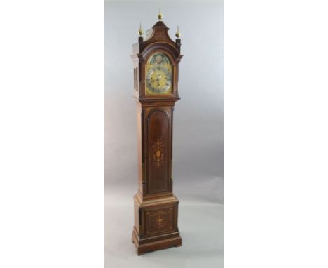 An Edwardian George III style marquetry inlaid chiming eight day longcase clock, the 10 inch arched brass dial with painted m