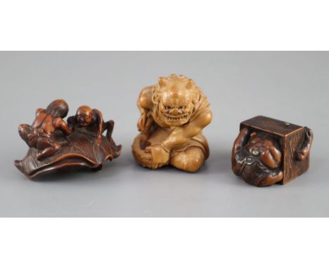 Three Japanese boxwood or cherry netsuke of oni, Meiji period, the first depicting a seated oni holding a paint brush and ink