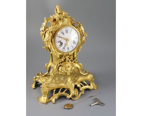 A 19th century French ormolu mantel clock, with ornate pierced foliate scroll case and enamelled Roman dial, unsigned eight d