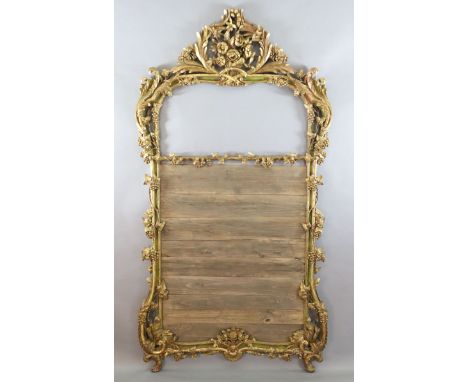 A 19th century giltwood overmantel mirror frame, carved with acanthus scroll, vines and flowers, lacks plate, width 4ft 1in. 