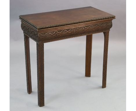 A George III mahogany card table, with ovolo carved rim and blind fret carved frieze incorporating a drawer, on chamfered leg