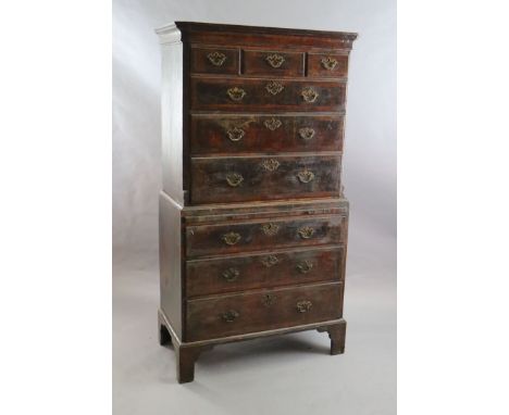 A mid 18th century featherbanded walnut chest on chest, fitted three short and six graduated long drawers with brushing slide