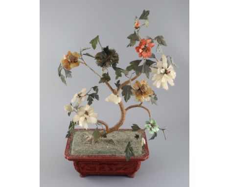 A Chinese jade and hardstone model of a tree, 19th century, comprising of nephrite, chalcedony and jadeite leaves and flowers