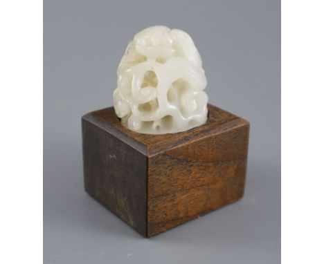 A Chinese white jade hat finial, carved in high relief and openwork with scrolling leaves and tendrils, 3.8cm high, later woo
