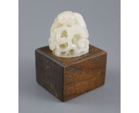 A Chinese white jade hat finial, carved in high relief and openwork with scrolling leaves and tendrils, 3.8cm high, later woo