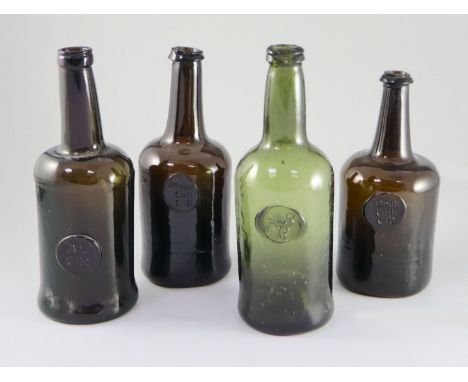 Four All Souls Common Room green glass sealed wine bottles, second half 18th century, in olive green/brown glass, two with 'A