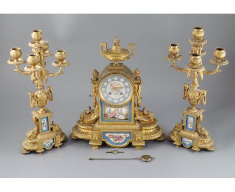 A 19th century Louis XVI style ormolu and Sevres style porcelain clock garniture, the mantel clock of architectural form with