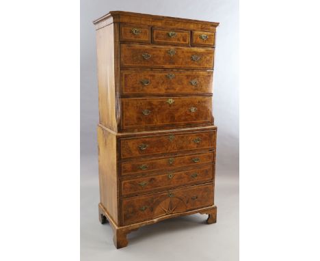 A George II figured walnut secretaire chest on chest, fitted three short and seven graduated long drawers, the lower drawer w