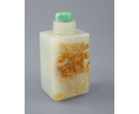 A Chinese pale celadon and russet jade rectangular snuff bottle, 19th century, the carver skillfully carving a bird in a frui