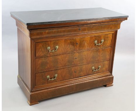 A 19th century French flame mahogany commode, with black granite top, divided frieze drawer and three further long drawers an