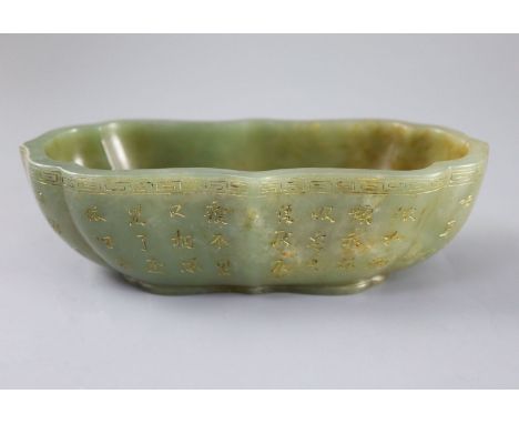 A Chinese inscribed green jade brushwasher, of ruyi outline, with engraved and gilt inscriptions to the outside and a Qianlon