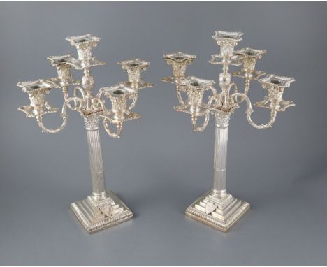 A pair of late Victorian silver corinthian column four branch, five light candelabra by Carrington &amp; Co, with scrolling a