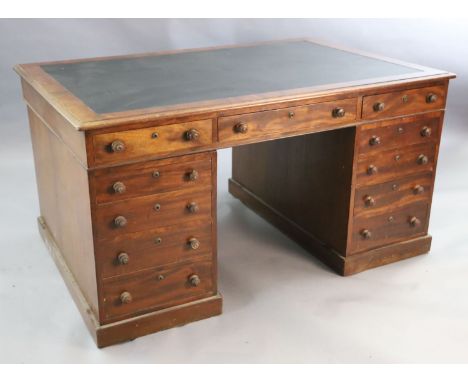 A Victorian mahogany twin pedestal partner's desk, with black leather skiver and eleven drawers opposing eleven further drawe