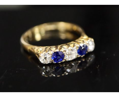 An early/mid 20th century 18ct gold and platinum, two stone sapphire and three stone old cut diamond half hoop ring, size Q/R