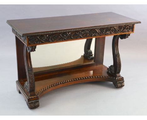 An early 19th century Anglo Indian padouk wood console table, with foliate carved frieze, front scroll supports and mirror ba