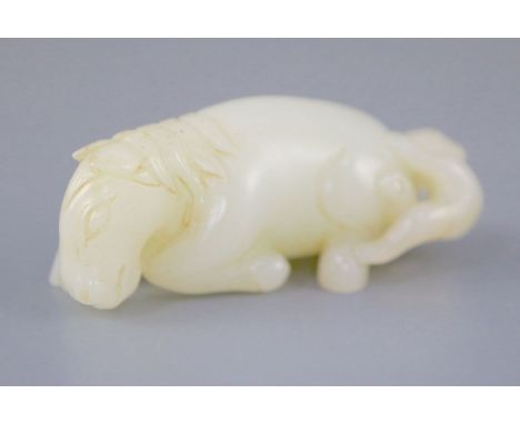 A Chinese white jade group of a recumbent horse and boy, the stone of good even tone with a small russet inclusion to the boy