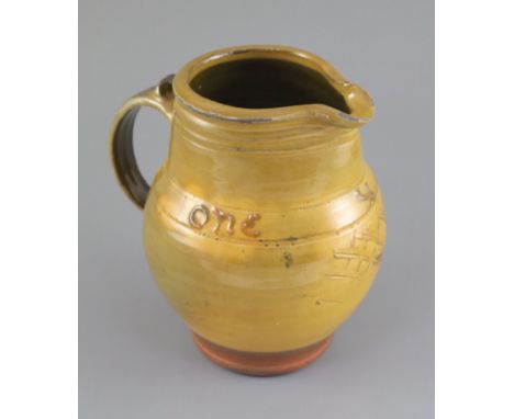 Bernard Howell Leach (1887-1979). A mustard-glazed slipware jug, 'one &amp; all' and sgraffito decoration, St Ives and early 