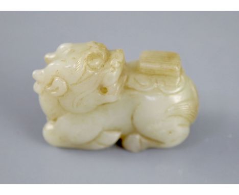 A Chinese pale celadon jade figure of a recumbent qilin, the stone with some russet inclusions, 5.4cmCONDITION: The figure ha