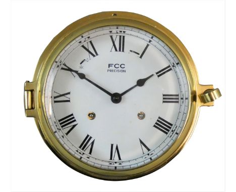 FCC, a 6" dial brass bulk head clock, the white enamel dial with Roman numerals and eight bells on/off lever, key.