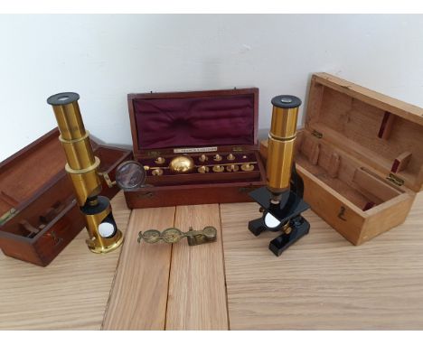 A Sykes hydrometer, by James Barry &amp; Co., case, a brass students microscope, case, another microscope, case and a  set of