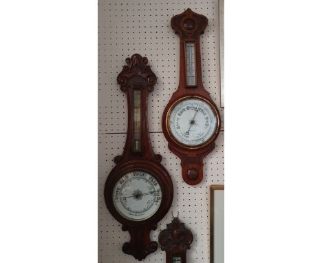 An Edwardian carved oak aneroid barometer with brass thermometer, 88 cm and another, retailed by J. Parker of Liverpool, glas