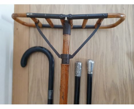 A vintage bamboo and steel shooting stick, 2 white metal mounted ebonised hardwood canes and a silver mounted walking stick (