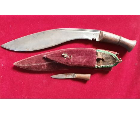 A Kukri with crescent stamp to the 31 cm blade, one small knife, scabbard.