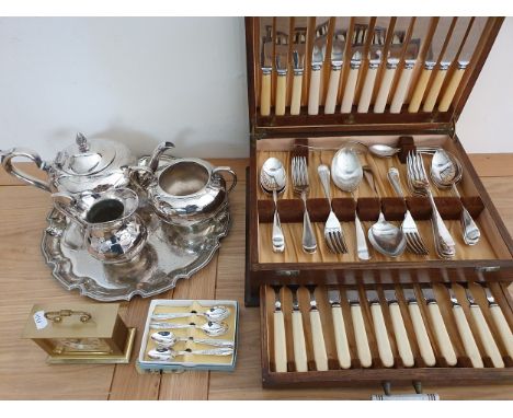 An electroplated canteen of cutlery, a plated tea service and a mantle clock.
