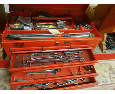 A six drawer tool chest with various spanners and other tools.