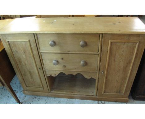 Vintage pine dog kennel type dresser base, having two drawers flanked by blind panelled doors on a platform base.(B.P. 24% in