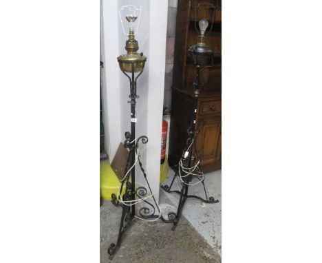 Two similar cast metal scroll decorated tripod standard lamps (originally oil burners). (2)(B.P. 24% incl. VAT)