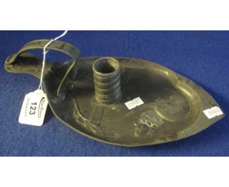 Kaiserzinn pewter, boat shaped chamber stick, with loop handle and relief foliate decoration. Cast mark to base. 29cm long. (