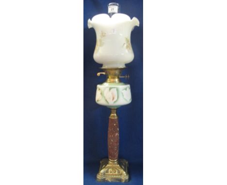 Early 20th Century brass double burner oil lamp with ceramic reservoir on marbled pedestal with repousse brass base, white gl