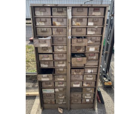 A very large metal set of engineers storage drawers with tools.