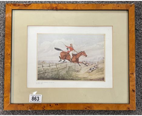 A print of an engraving titled A First Rate Workman Of Melton by Henry Aitken depicting a Jumping fox hunting horse