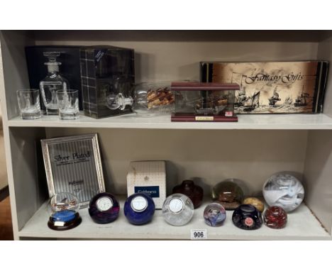 A glass ship in bottle, good selection of paperweights including Caithness clocks etc