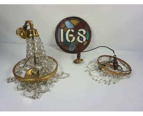 Two cut glass and gilt brass hanging electric light fittings, one with faceted drops radiating from a circlet, the other simi