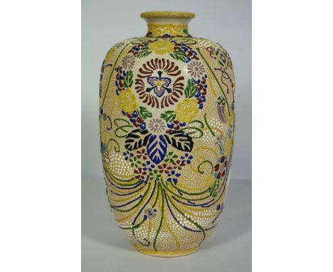 A Japanese stoneware bottle vase, with speckled enamel decoration, 20th century, in enamel colours and decorated with flowers