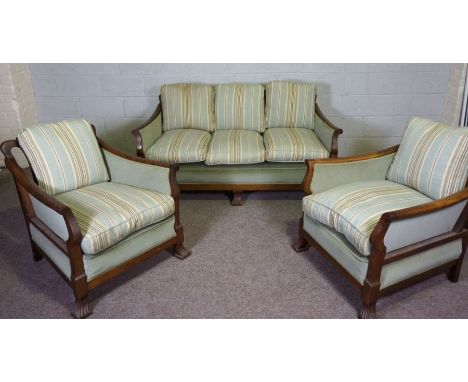 An early 20th century three seat Bergere suite, with hardwood frames, caned backs and currently upholstered in striped light 