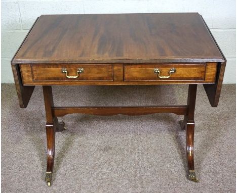 A George III style mahogany sofa table, 20th century,&nbsp;with a rounded rectangular drop leaf top over two drawers and two 