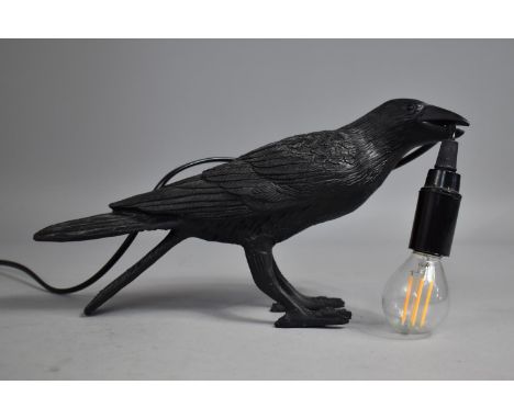 A Novelty Table Lamp in the Form of a Crow Holding Bulb, 30cms Long 