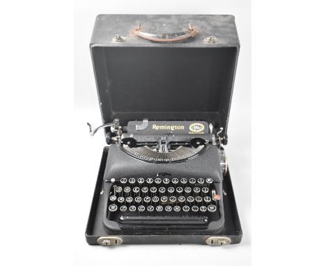 A Vintage Cased Remington Manual Portable Typewriter with Booklet