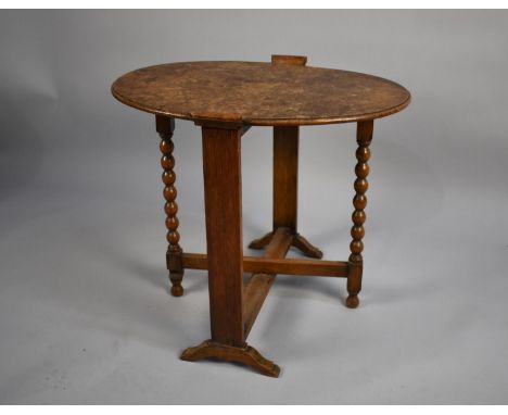 An Edwardian Oak Oval Topped Screen/Table with Bobbin Supports 