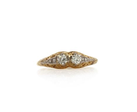 An American Art Deco two colour gold, two stone diamond ring,  with a pair of old brilliant cut diamonds, claw set side by si