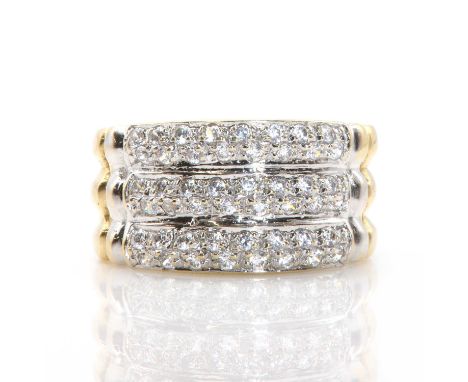 An 18ct gold and cubic zirconia dress ring, three rows of circular cut cubic zirconia, bead set in white to the hollowed ring