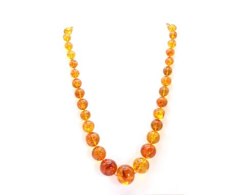 A graduated clarified amber bead necklace,with graduated off round clarified amber beads, approximately 10.50mm to 27.00mm di
